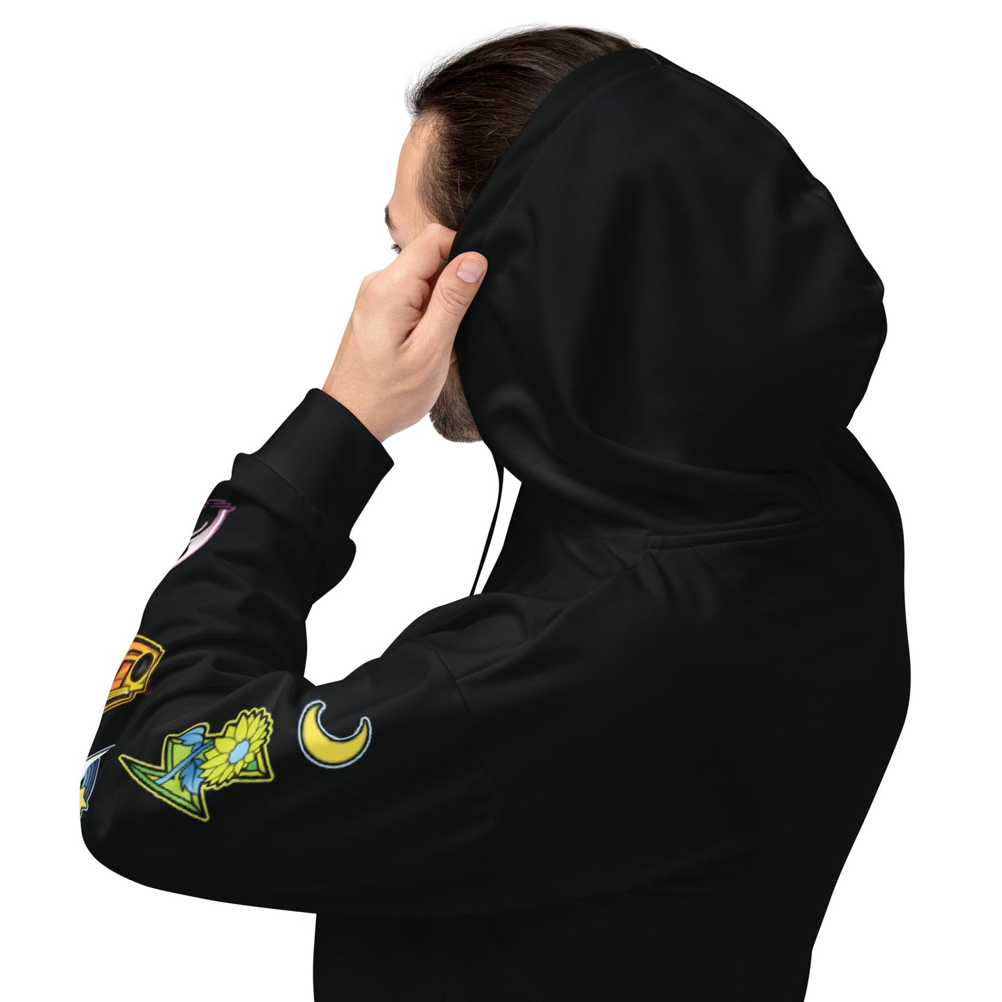 Left sleeve of black hoodie featuring colorful patches: a yellow flower, crescent moon, and various geometric shapes.