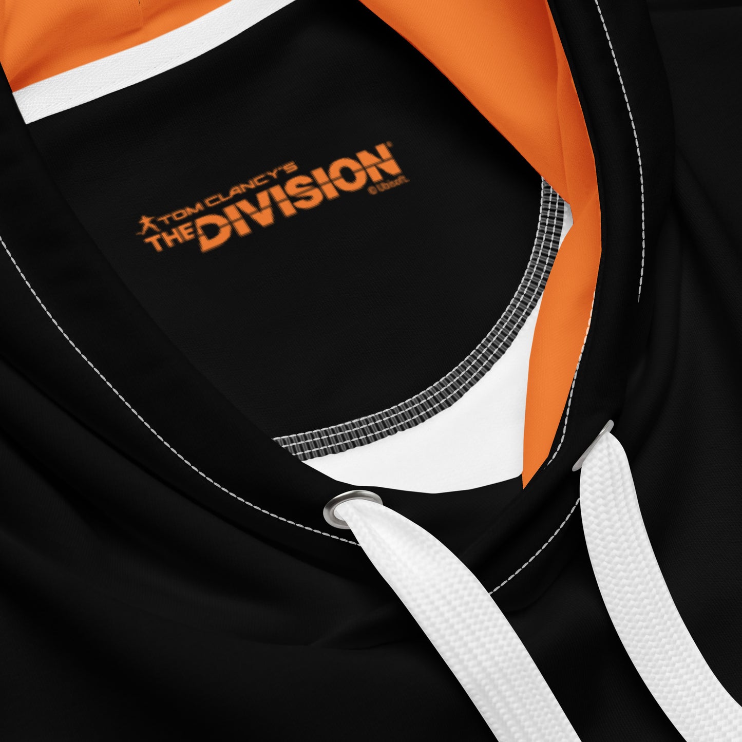 Black hoodie with orange lining and white drawstrings. Internal label shows "TOM CLANCY'S THE DIVISION" in orange text.