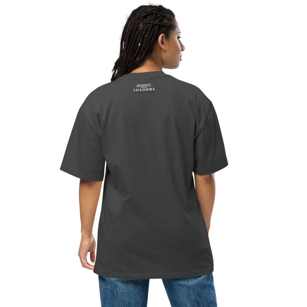 Rear view of a person wearing an 'Assassin's Creed Shadows' dark grey t-shirt and blue jeans.
