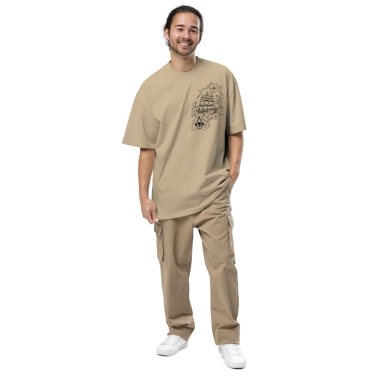 Tan t-shirt with a black line drawing on chest: sailing ship, compass rose, and Assassin's Creed skull logo.