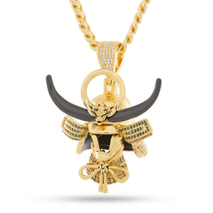 Gold samurai helmet pendant with black horns, white and blue gems, on a gold chain.