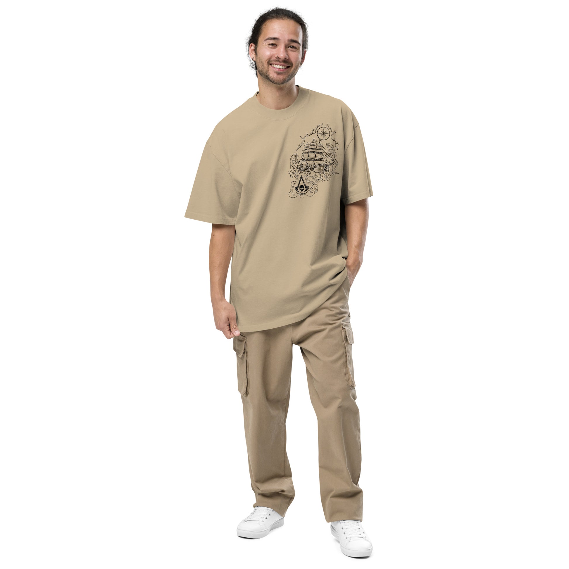 Tan t-shirt with a black line drawing on chest: sailing ship, compass rose, and Assassin's Creed skull logo.