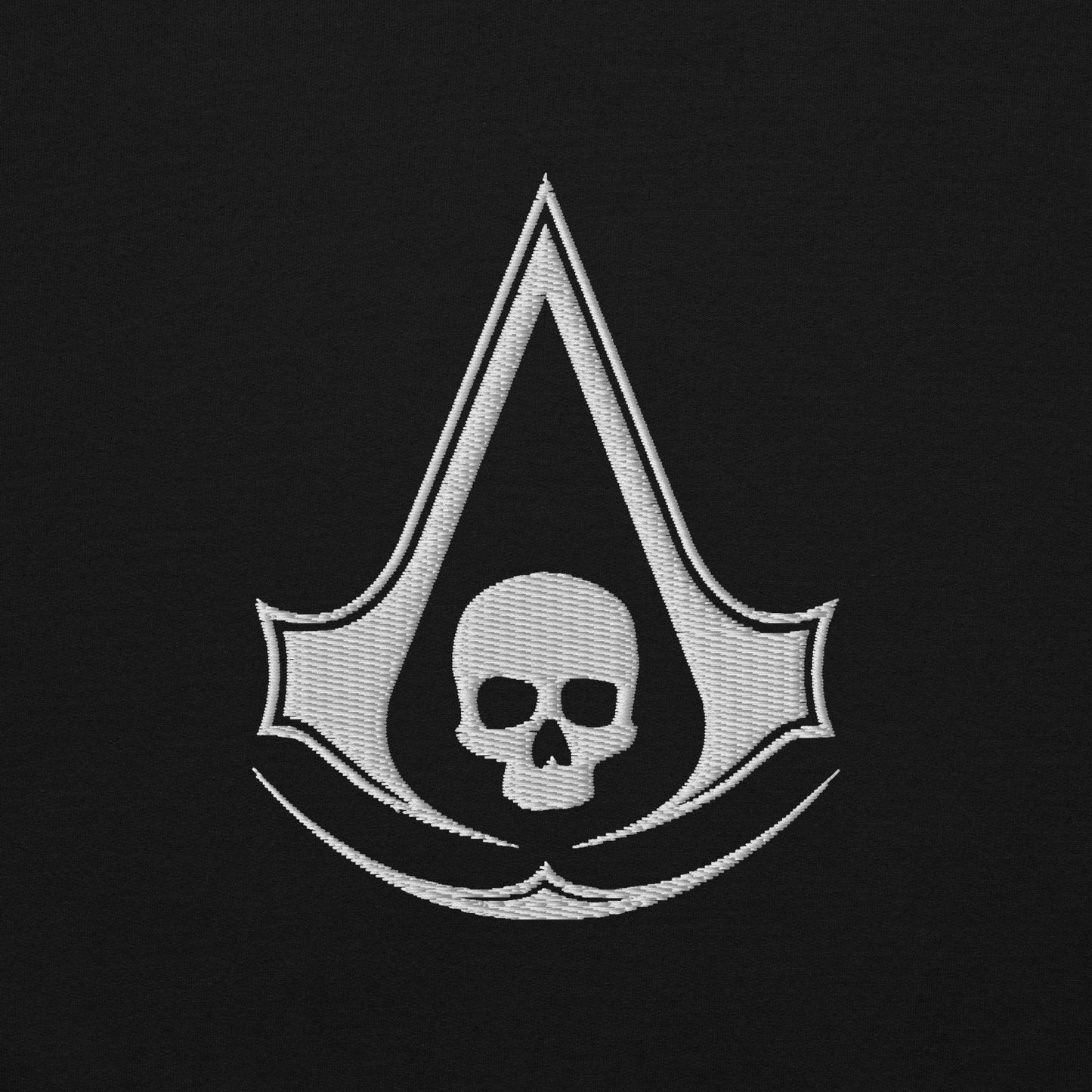 White embroidered Assassin's Creed symbol integrated with a skull, on black fabric.