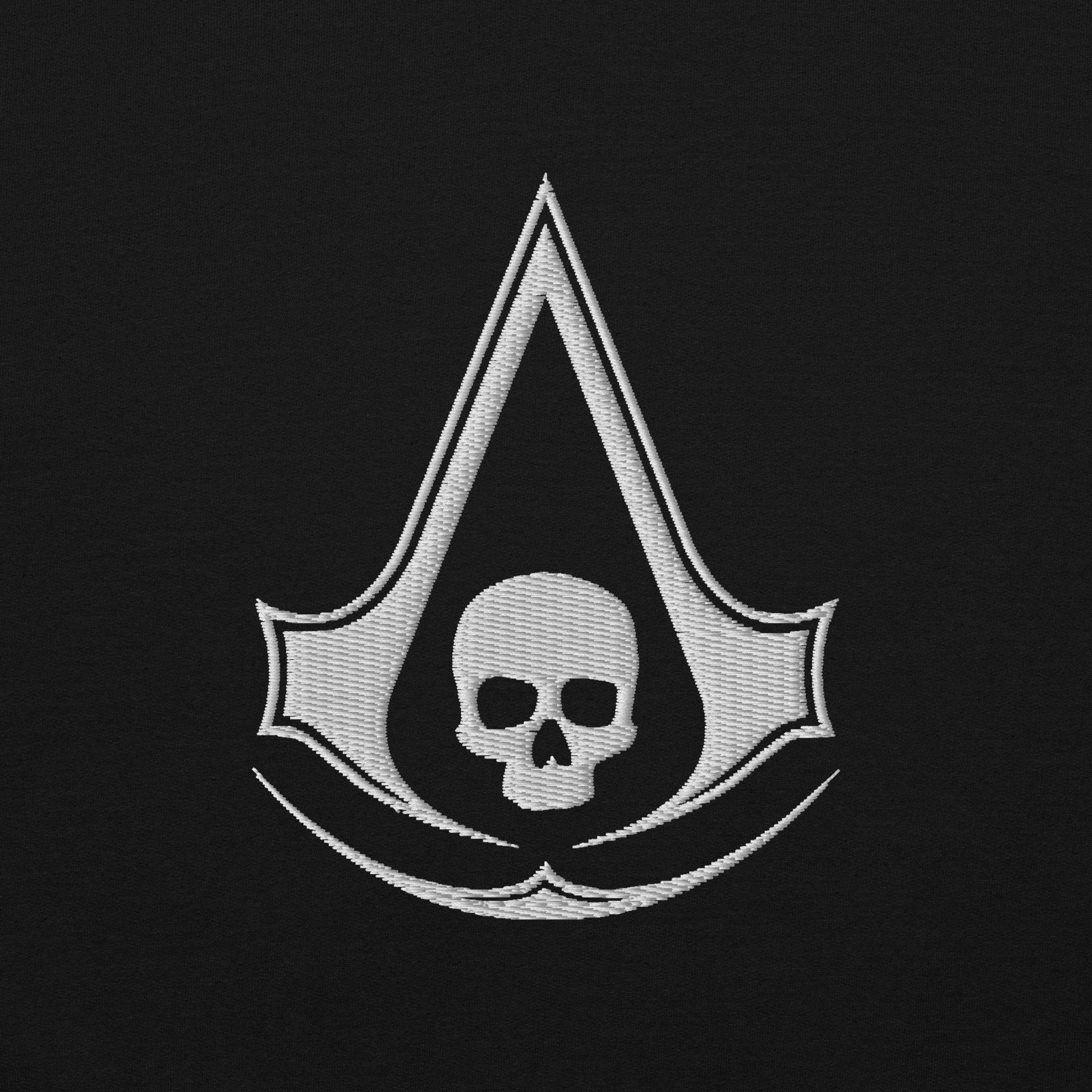 White embroidered Assassin's Creed symbol integrated with a skull, on black fabric.